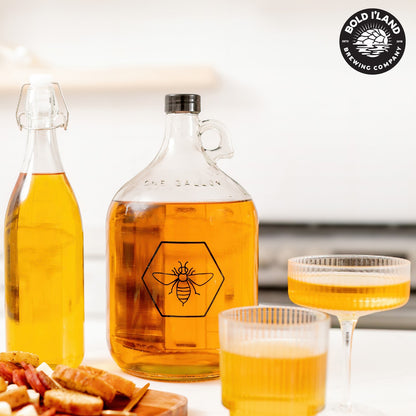 Mead carboy and glasses beside a serving board
