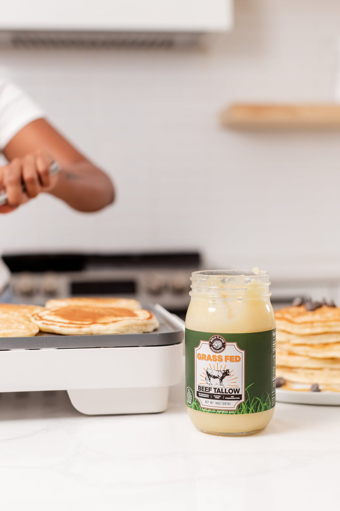 Grass fed beef tallow beside a pancake breakfast; serving suggestion